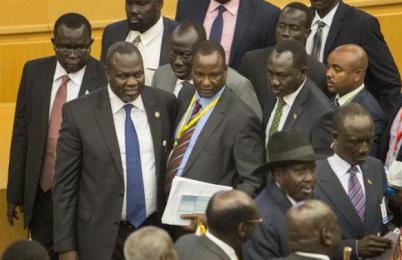 South Sudan's rebel leader Riek Machar, second left, looks across after shaking hands with South Sudan's President Salva Kiir, center-right wearing a black hat, after lengthy peace negotiations in Addis Ababa, Ethiopia Monday, Aug. 17, 2015 (Photo AP/Mulugeta Ayene)