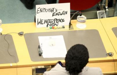 South Sudan's delegate display a protest poster during a peace signing attended by leaders from the region in Addis Ababa, August 17, 2015.(Photo Reuters/Tiska Negeri)