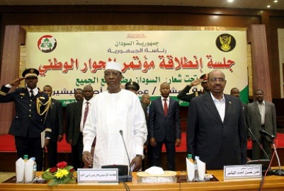 Sudan's President Omer al-Bashir and his Chadian counterpart Idriss Deby (L) listen to the national anthem during opening session of Sudan National Dialogue conference in Khartoum October 10, 2015. (Photo SUNA)