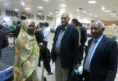 Civil Society Initiative (CSI) delegation members Galeela Khamis (L), Abdallah Musa (C) and Babiker Mohamed al-Hassan wait to collect their belongings after their arrival to Khartoum airport on Nov 16, 2015. (Picture taken by Mariam al-Mahdi)