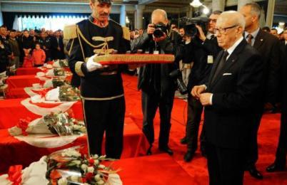 Tunisia's President Beji Caid Essebsi, right, attends a funeral ceremony held at the Presidential Palace in Carthage near Tunis, Tunisia, to honour the members of the Republican Guard killed in Tuesday's bomb blast on a bus, Wednesday, Nov. 25, 2015. (Photo AP/Hassene Dridi)