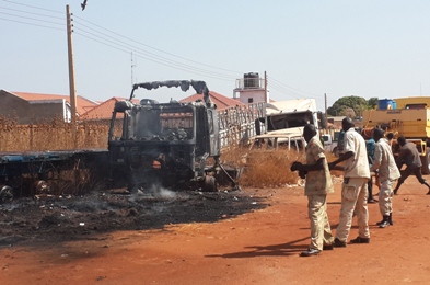 WBGS firemen train their hoses during a fire at an open storage area of plastic pipelines in Wau, on December 18, 2015 (ST Photo)