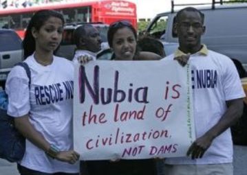 Protesters stand outside the United Nations building in New York on June 7, 2007 holding signs protesting the construction of Sudan’s Kajbar Dam. (courtesy photo of Nubian activists)