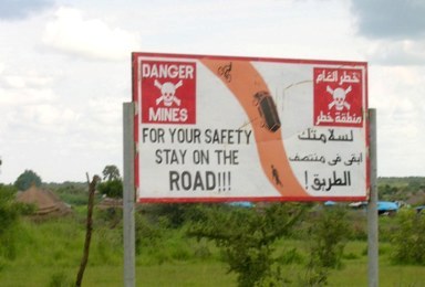 Sign warning drivers in South Sudan to stay on the road or they might encounter land mines (Photo minefields.com)