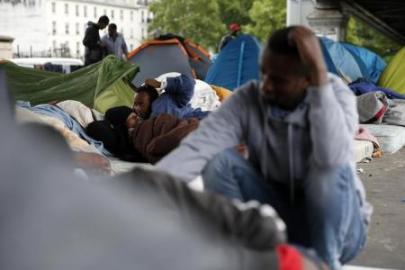 Migrants from Eritrea sit near tents as they live in a make-shift camp under a metro bridge in Paris, France, May 28, 2015. (Photo Reuters/Benoit Tessier)