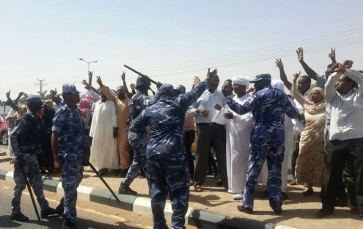 In this picture released by activists, Riot policemen ask protesters to disperse from in front of Rotana Hotel in Khartoum on Wednesday 17 February 2016