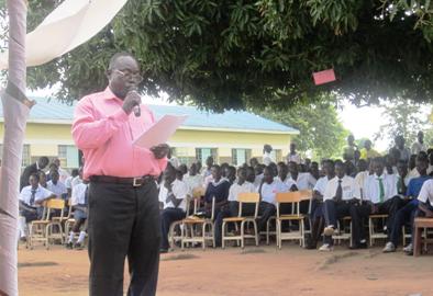 A photo from Yei Day school's FaceBook page shows a teacher addressing students in an annual event