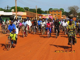 Bicycle riders and two women carrying pots in Yambio town March 28, 2016 (ST)