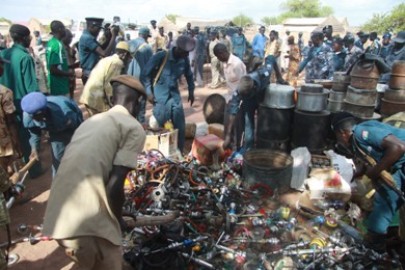 Policeman destroying beer and Shisha in Gogrial State (ST Photo)
