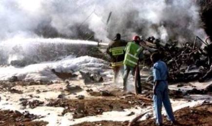 Firefighters put out a fire on the wreckage of a military plane at El-Obied airport on 30 April 2016.