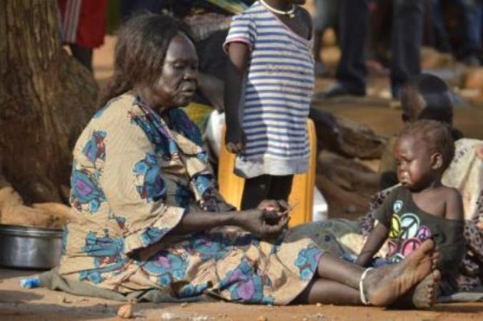 In this Tuesday July 12, 2016 photo, a woman sits with her child near a church in Juba, South Sudan.  (AP Photo)