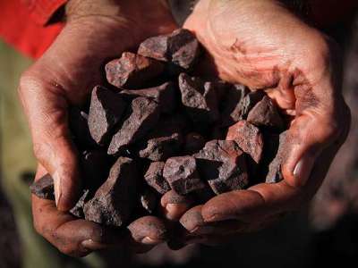 a_south_african_employee_displays_iron_ore_at_the_sishen_mine_bloomberg_file_photo_.jpg