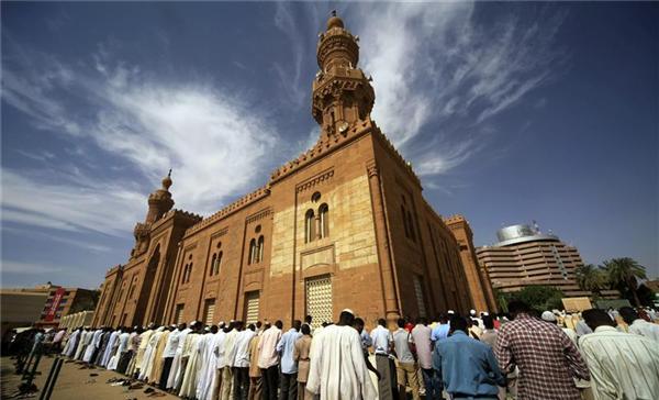 Muslims stand outside the Grand Mosque during Friday prayers in Khartoum November 9, 2012. (Reuters/Mohamed Nureldin Abdallah Photo)