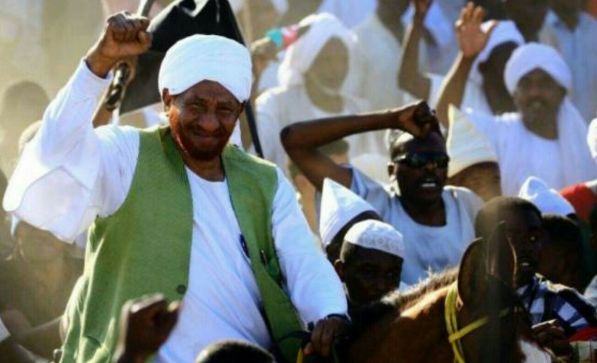 Al-Mahdi, ridding a horse, waves hands to his supporters after his arrival to Sudan on 26 January 2017 (ST Photo)