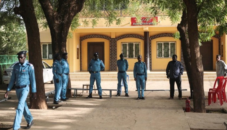 Sudanese security forces stand guard at a polling station on the first day of presidential and legislative elections, in Khartoum, Monday, April 13, 2015. (AP Photo/Mosa'ab Elshamy)