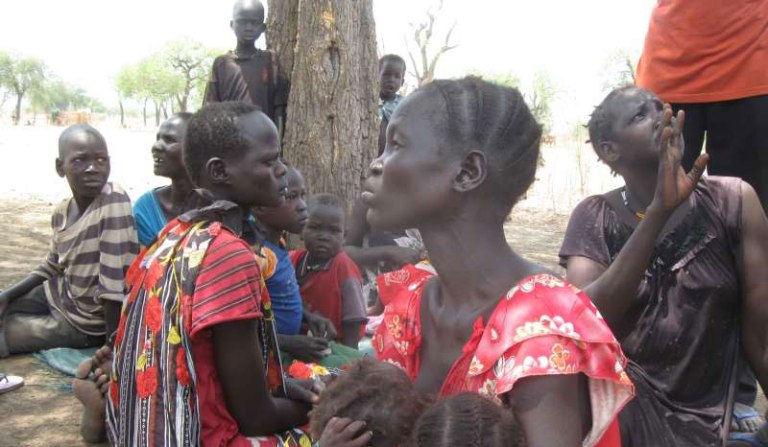 Displaced women and children under a hot sun in South Sudan's Maban County, where food shortages are causing tension. (UNHCR/P. Rulashe Photo)