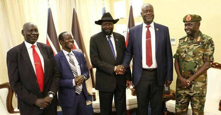 President Kiir (C) shakes hand with his Defence Minister Manyang Juuk at the swearing ceremony of the new chief of staff Gen James Ajong (R) with VP James Wani and Advisor Daniel Awet Akot. on 10 May 2017