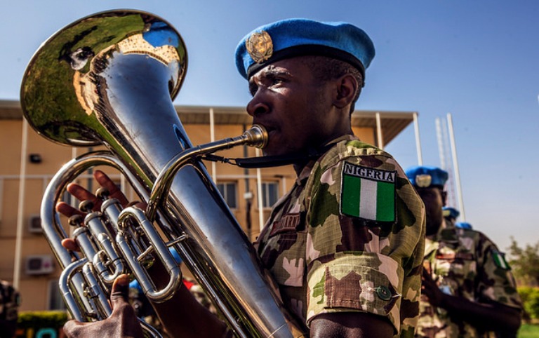 A Nigerian peacekeeper plays a tuba trombone  in a march to celebrate the  Peacekeepers Day in El Fasher on May 29, 2017  (UNAMID Photo)