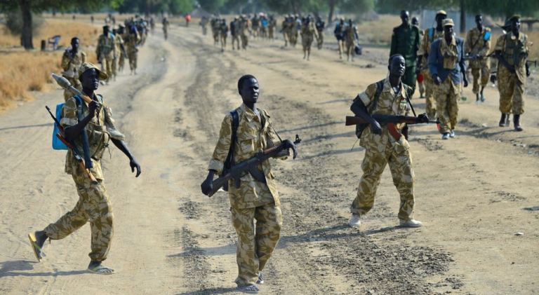 Sudan People's Liberation Army soldiers walk along a road near Bor, on January 31, 2014 (AFP Photo)