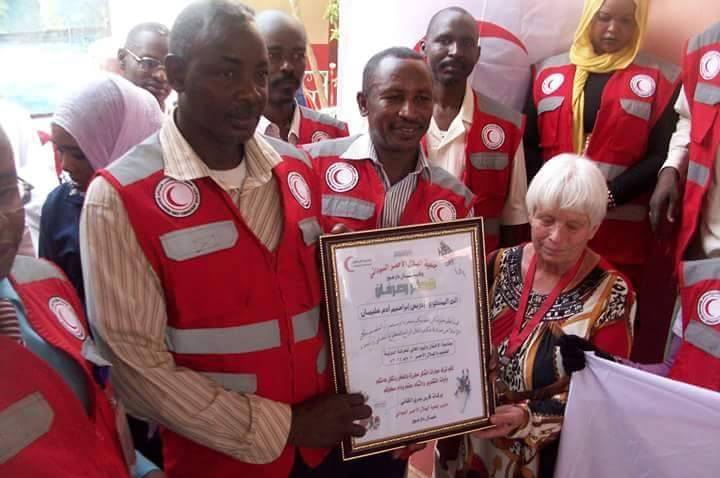 Margaret Schenkel poses for picture with Red Crescent Society workers in North Darfur (ST file photo)