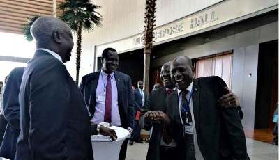 South Sudan information minister Michael Makuei Lueth shakes hands with Lam Akol during the revitalization forum on 19 December 2017 (ST Photo)