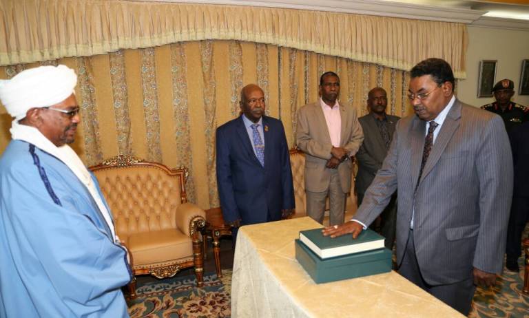 NISS's Director Salah Gosh (R) takes the oath of office before President Omer al-Bashir (L) at the Sudanese presidency in Khartoum on February 11, 2018.  (ST Photo)