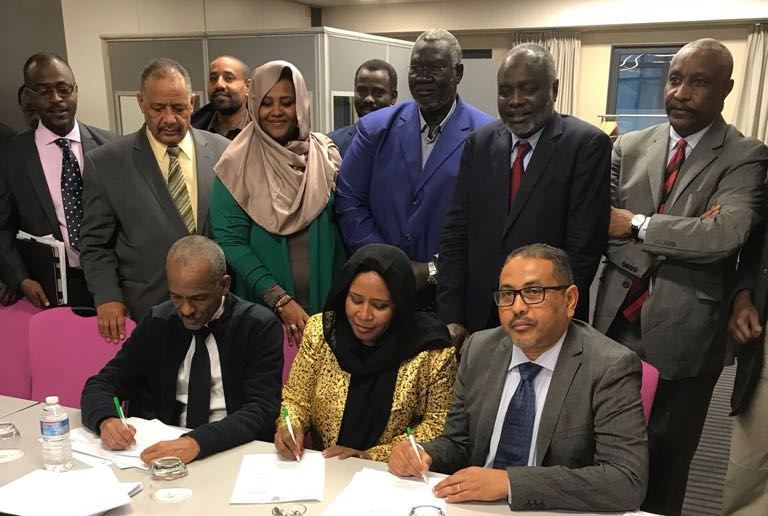 Beja Congress SG Ossama Said, civil society representative Najla Mohamed Ali and Alamin Daoud of UPFLJ sign the eastern Sudan in Paris on 17 March 2018 (ST photo)