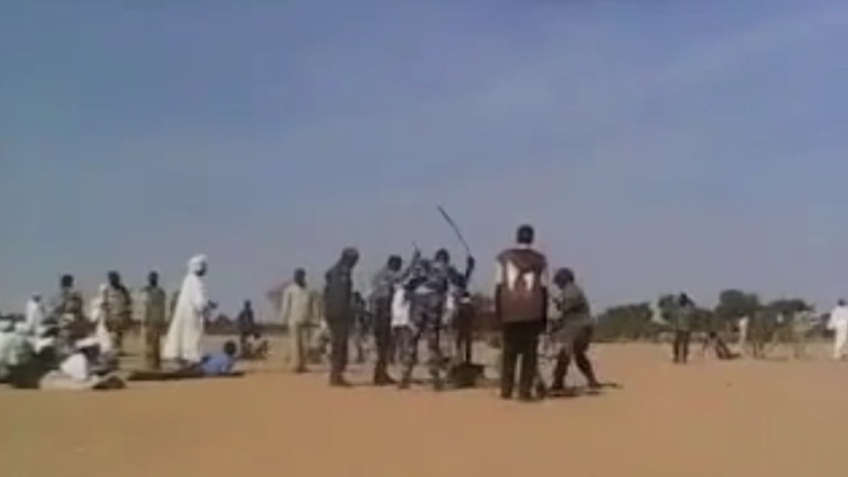 Government forces interrogating and beating villagers during a weapons collection exercise in Artala.  Screenshot from a video released on 10 March 2018 (ST Photo)