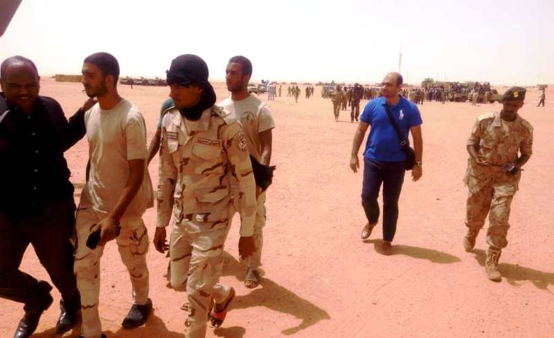 The 5 freed Egyptian soldiers escorted by Sudanese and Egyptian security officers to board a plane in unknown location on 30 July 2018 (ST Photo)