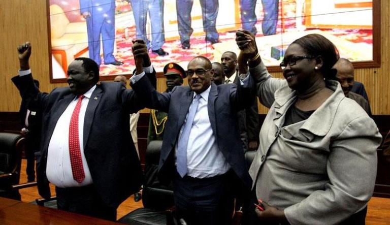 S. Sudan Government and opposition delegates wave hands with the Sudanese FM after the signing of the power sharing deal in Khartoum on 25 July 2018 (SUNA photo)