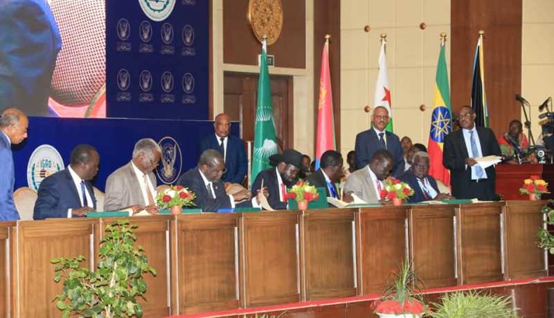 President Kiir, (C) Machar and other opposition leaders sign the agreement on outstanding issue on governance on 5 August 2018 (ST Photo)
