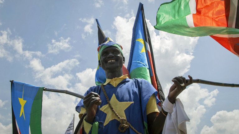 A man waves South Sudanese national flags during peace celebrations in the capital Juba, South Sudan Wednesday, Oct. 31, 2018 (AP Photo)