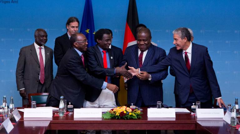 Sudanese government and rebel officials shake hands after the signing of the pre-negotiations agreement in Berlin on 6 December 2018 (ST Photo)