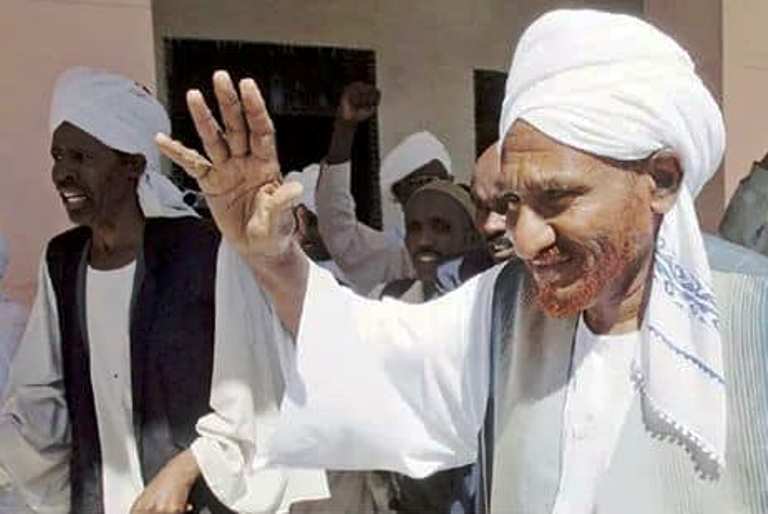Al-Mahdi waves hand to his supporters after his arrival in Khartoum on 19 Dec 2018