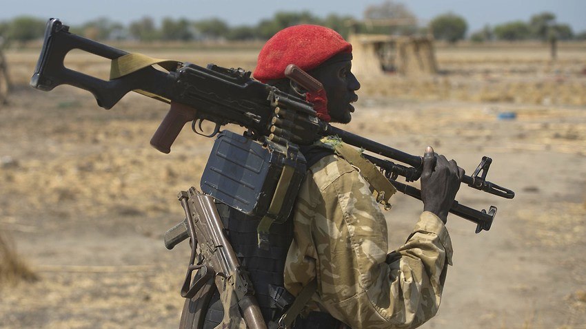 An armed South Sudanese government soldier stands near a village in Bor  on January 26, 2014 (Photo AFP)