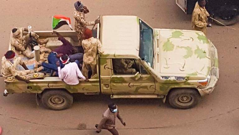 A Sudanese protester continues to raise the national flag after his arrest by security agents in Khartoum on 7 February 2019 (ST Photo)