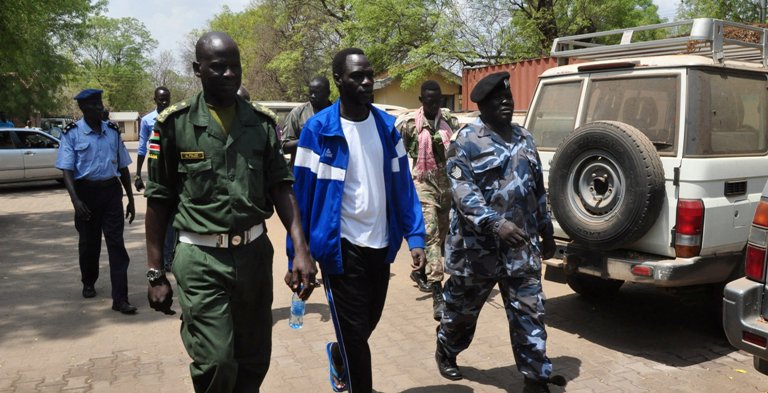 James Dak surrounded by police is heading to the court on 12 February 2018 (Photo Reuters)