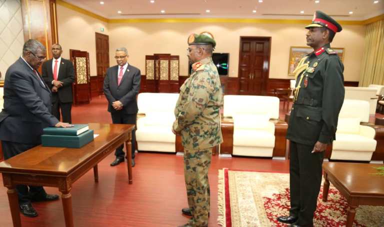 Sudanese President Omer al-Bashir swears in Mohamed Tahir Ela (L) as the country's new prime minister on February 24, 2019 (ST photo)