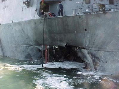 The port side damage to the guided missile destroyer USS Cole is pictured after a bomb attack during a refueling operation in the port of Aden in this October 12, 2000 (Reuters file photo)
