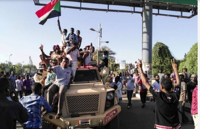 Protesters ridding a military truck together with Sudanese soldiers outside the army headquarters in Khartoum on 7 April 2019 (ST photo)