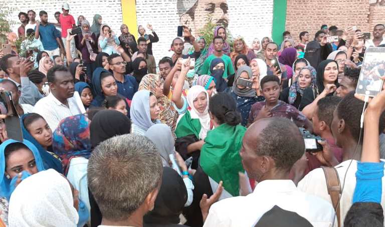 The crowd of protesters surround the mother of one of the victims of the 3 June attack  outside their house of in Khartoum as on 13 July 2019 (ST photo)
