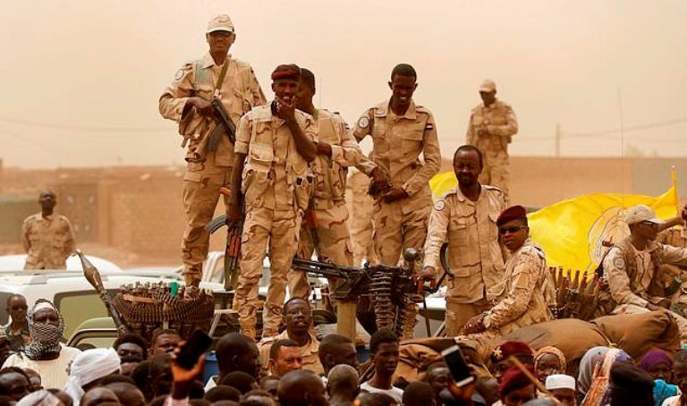 Sudanese soldiers from the Rapid Support Forces stand on their vehicle during a military-backed rally, in Mayo district, south of Khartoum,on June 29, 2019 (AP Photo)