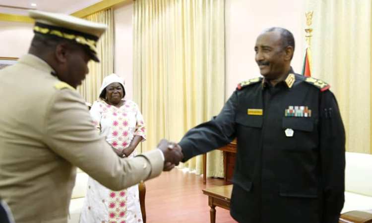 CAR' Defence Minister Marie-Noëlle Koyara smiles while Sudan's al-Burhan shakes hands with a military member of her delegation in Khartoum n 4 Nov 2019 (Sovereign Council photo)