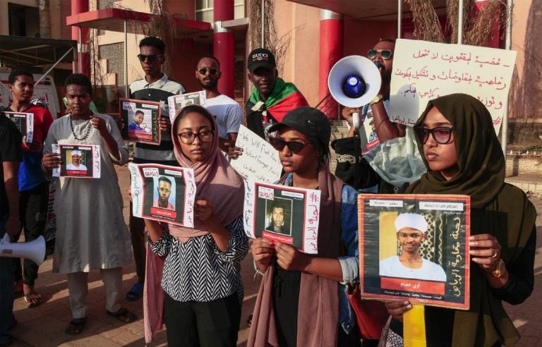 Sudanese demonstrators holding banners demanding justice for the killed and missing protesters last November 2019 (AFP-file Photo)