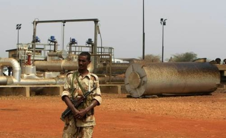 Sudanese soldier guards and oil facility