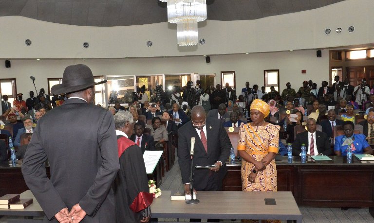 South Sudan's FVP Machar swearing in as his wife stands besides him on 22 Feb 2020 (SSPPU photo)