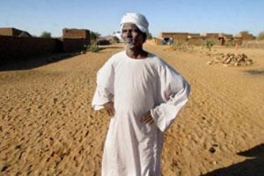 fadul_saim_a_leader_of_the_zayadia_arab_tribe_stands_in_the_middle_of_a_road_which_divides_the_neighborhood_between_arabs_and_black_africans._krt.jpg