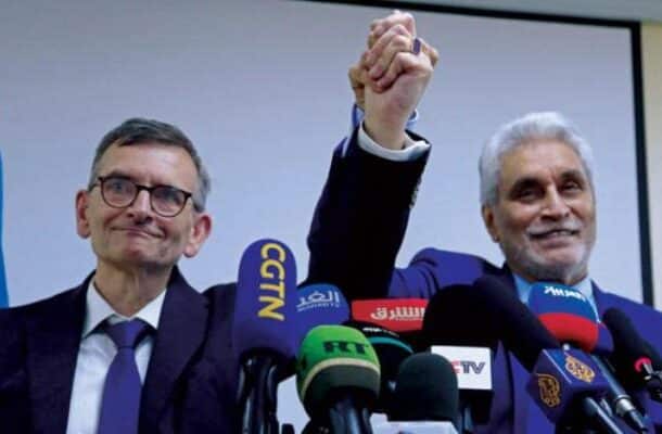 Lebatt and Perthes raise hands at a press conference on March 10, 2022