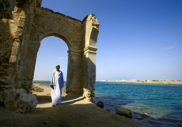A Sudanese man stands at an archaeological site in Suakin Island on the Red Sea (AFP)