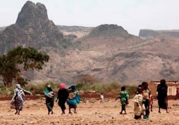 Villagers walk in the war-torn town of Golo in central Darfur. (AFP photo)